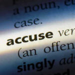 Close-up dictionary definition of accuse underlined.