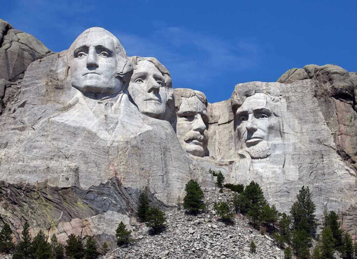 Mount Rushmore with four presidential faces carved in rock.