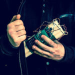 Person holding a homemade explosive device.