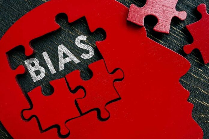Red puzzle pieces forming a head silhouette with the word 'BIAS' inside