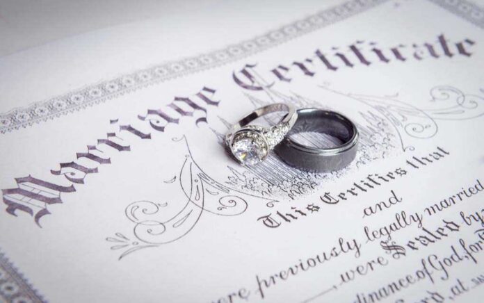 Wedding rings placed on a marriage certificate