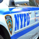 Mysterious NYPD Uniforms Dumped — Timing SHOCKING NYPD police car with logo and text.