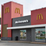 McDonalds SUED – Forty-Two Year Old LIE EXPOSED McDonalds restaurant exterior with logo and drive-thru sign.