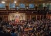 A crowded congressional chamber with members in discussion