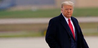 Donald Trump walking outdoors in formal attire