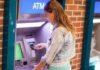 Trump Orders Banks to Look at Citizenship Status! Young woman using an ATM in an urban environment