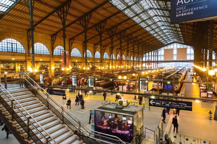 shutterstock_161952056 Interior view of a busy train station with large windows and a staircase