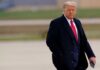 Donald Trump walking outdoors in formal attire