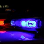 Racist Livestreams Courthouse Gunfight! Close-up of police lights flashing in blue and red at night