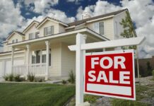 Governor Looks To ERASE Property Taxes! A suburban house with a For Sale sign in the front yard