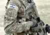 Infant Killed In Military Blunder! Soldier in camouflage gear with Israeli flag patch.