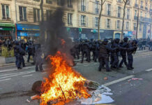 Protestors BREAK Police Officer’s Back! Protesters and police clash; fire in the street.