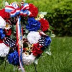 A patriotic memorial wreath adorned with red, white, and blue flowers