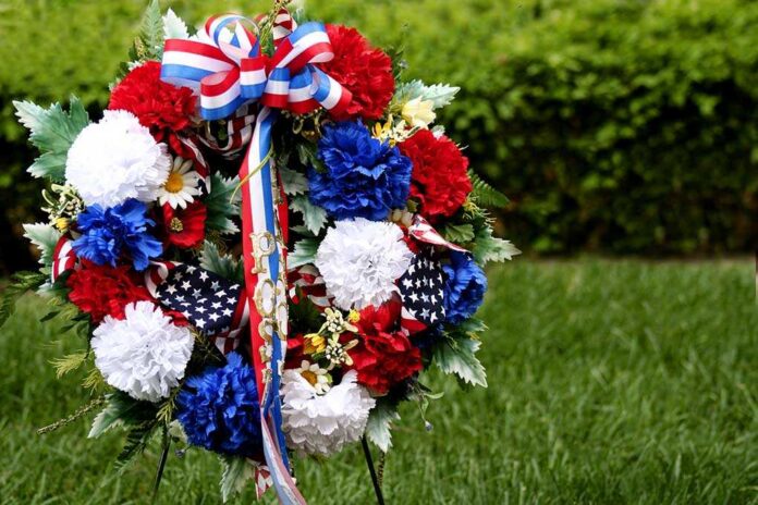 Memorial,Day,Wreath,Of,Flowers A patriotic memorial wreath adorned with red, white, and blue flowers