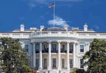 White House Brawl ERUPTS In Front Of Trump The White House with the American flag flying against a blue sky
