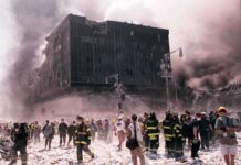 Emergency responders and civilians amidst debris at a disaster site