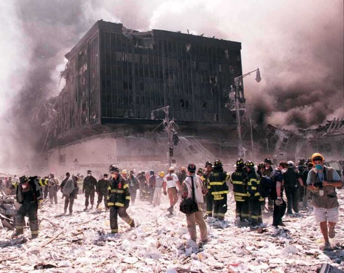 Emergency responders and civilians amidst debris at a disaster site