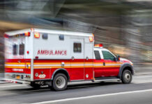 Woman BIRTHS Baby Middle Of A Traffic Jam! Red and white ambulance driving on street.