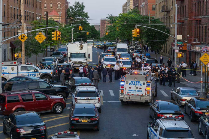 Police activity on a city street with emergency vehicles.