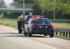 Trump DEMANDS ICE Traffic Stops Resume Despite 2 Shootings This Week Police officer conducting a traffic stop on a highway