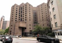 Brutalist high-rise detention facility on a city street