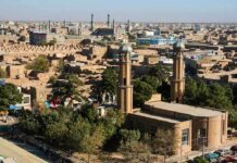 Lt. Governor Targets Public Muslim Prayers Aerial view of a city featuring traditional buildings and minarets