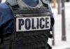 Police officer wearing a tactical vest with large POLICE patch
