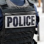 Police officer wearing a tactical vest with large POLICE patch