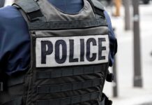Police officer wearing a tactical vest with large POLICE patch