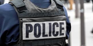 Police officer wearing a tactical vest with large POLICE patch