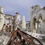 Arson Hits 140-Year Church—Mosque Plan Erupts Interior view of a destroyed building with collapsed arches and debris
