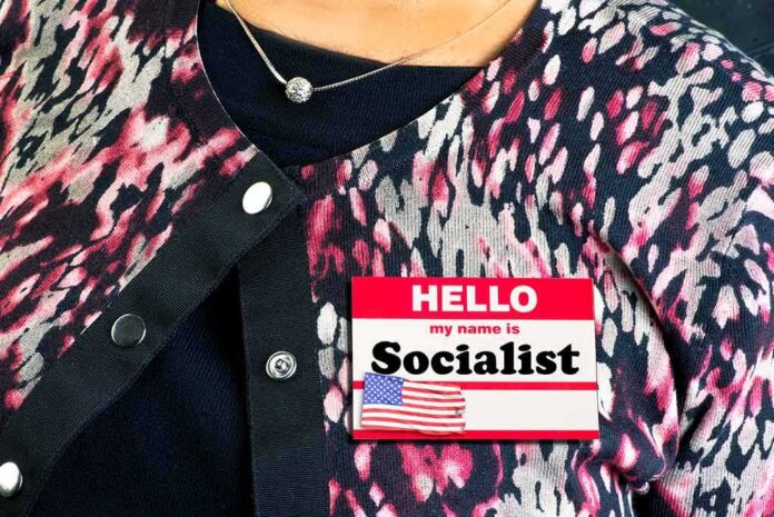 shutterstock_1293862489 Person wearing patterned cardigan with a name badge on chest