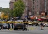 FBI Arrests Possible Assassin Police investigate a taped-off urban street crime scene