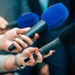 Black Woman Found HANGING From Tree – National OUTRAGE! Reporters holding colorful microphones