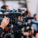 Pilot Jumps Out Plane Mid-Flight! Video cameras on tripods at a media event