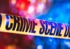 Veteran GUNS DOWN Masked Intruder – He Picked The Wrong House Crime scene tape with blurred emergency lights in background