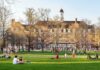 Two Sudden Deaths Rattle College Campus Students relaxing on a campus quad in front of a brick academic building