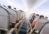 Cabin Chaos – Roof Caves Midflight! Airplane cabin aisle with blurred passengers and seats