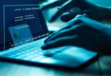 Hands typing on a laptop with cybersecurity login overlay