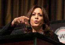 Woman speaking at a podium and gesturing with her hand