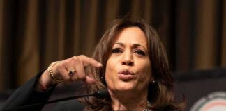 Woman speaking at a podium and gesturing with her hand