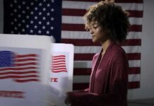 Socialist Frontrunner Admits to Bipolar Disorder Voter at a polling booth with an American flag backdrop
