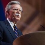 John R. Bolton speaking at a podium