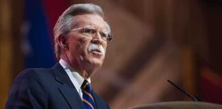John R. Bolton speaking at a podium