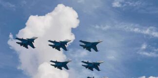 Six fighter jets flying in formation against a blue sky