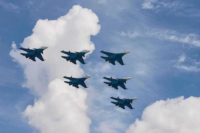 Six fighter jets flying in formation against a blue sky