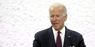 man in suit speaking at a podium
