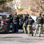 State of Emergency DECLARED – Entire System Down! Police and sheriff officers gather around vehicles on a suburban street