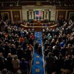Legislative chamber audience stands and applauds