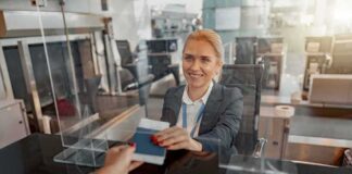 airport check-in agent handing back a passport